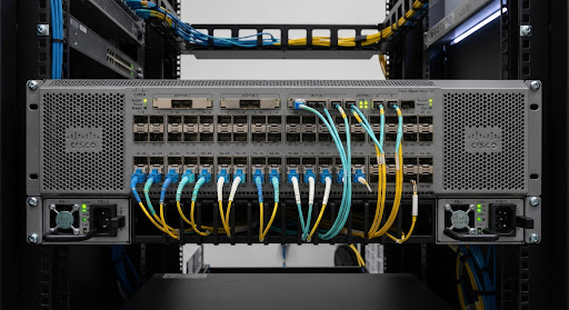 Cisco Nexus 9300 series datacenter spine leaf high density optical switch faceplate showing QSFP and SFP28 sockets with ventilation design in precision datacenter lab lighting